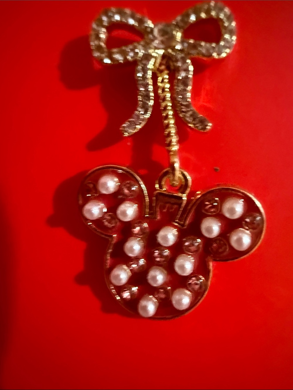 Disney x BaubleBar holiday bow earrings feature a dangling red Minnie Mouse head - Picture 2 of 4